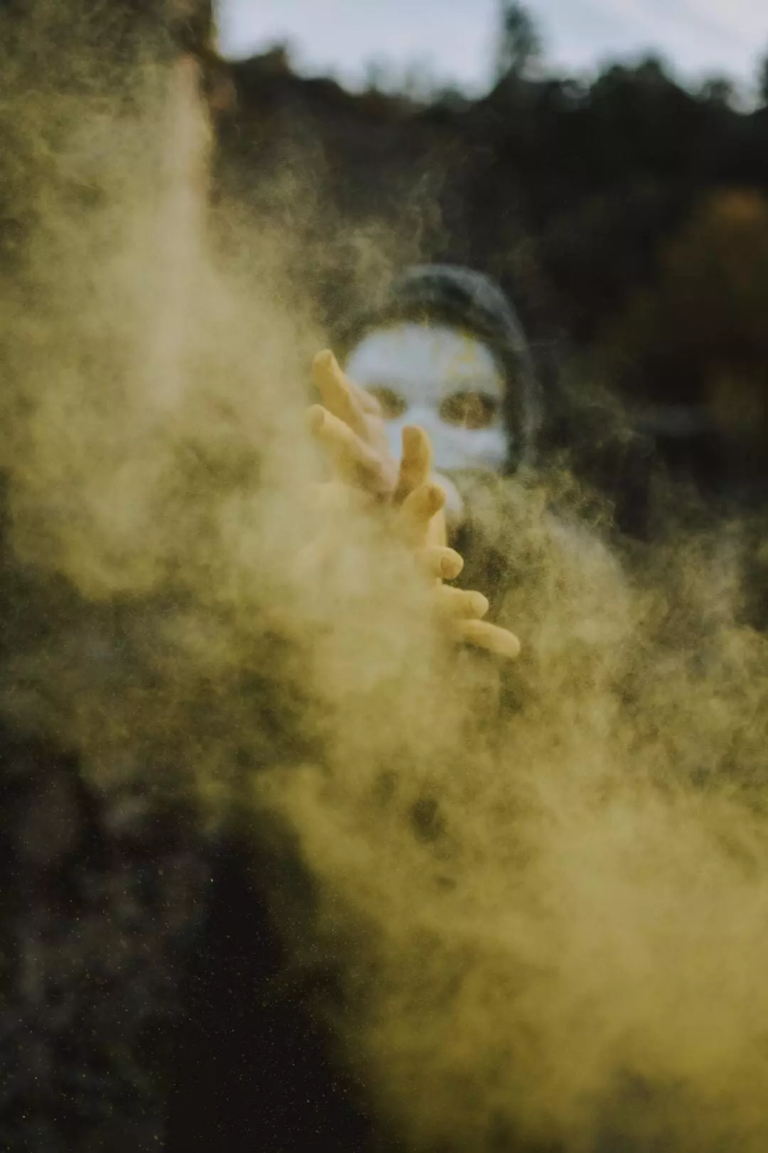A person with a mask creating a smoke illusion