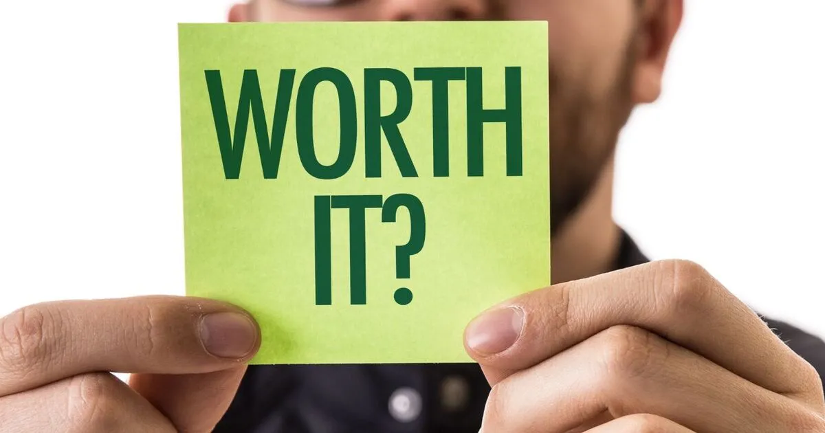 A man holding a stick it note showing that self worth is worth it.