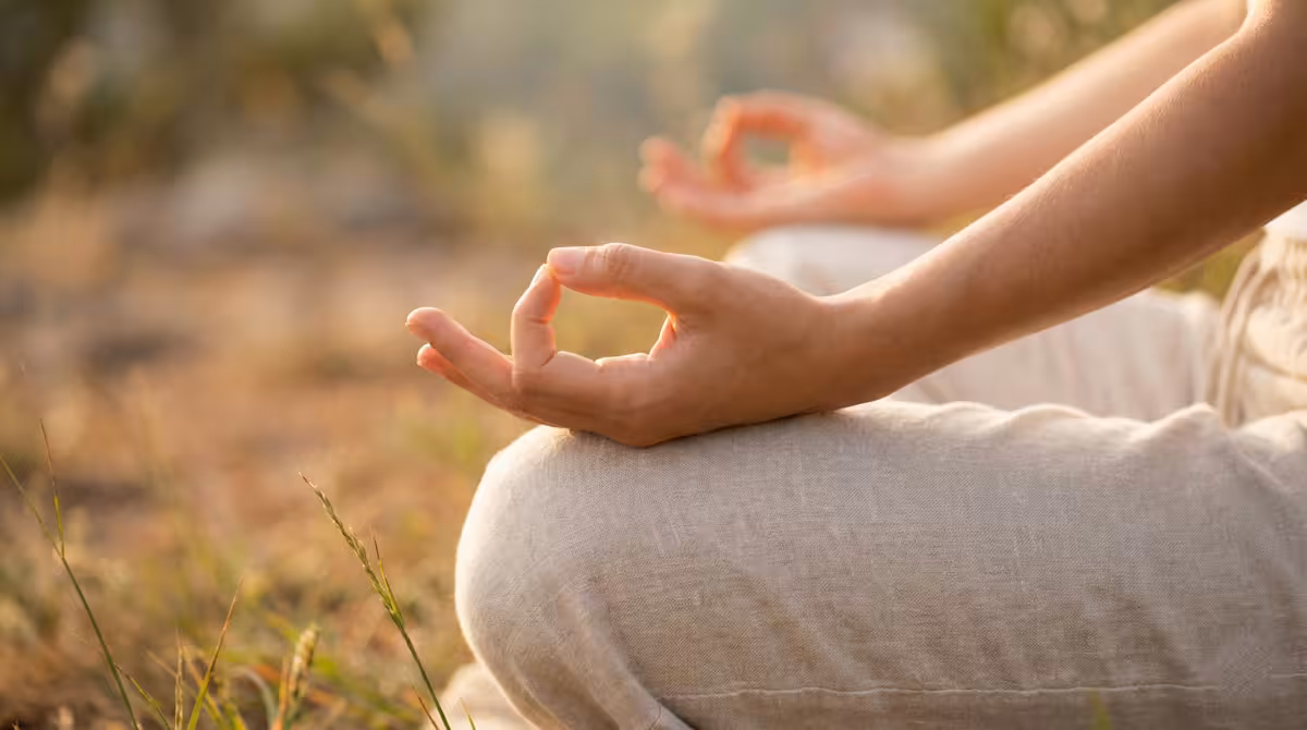 Close-up of hands in meditation mudra position during spiritual energy practice