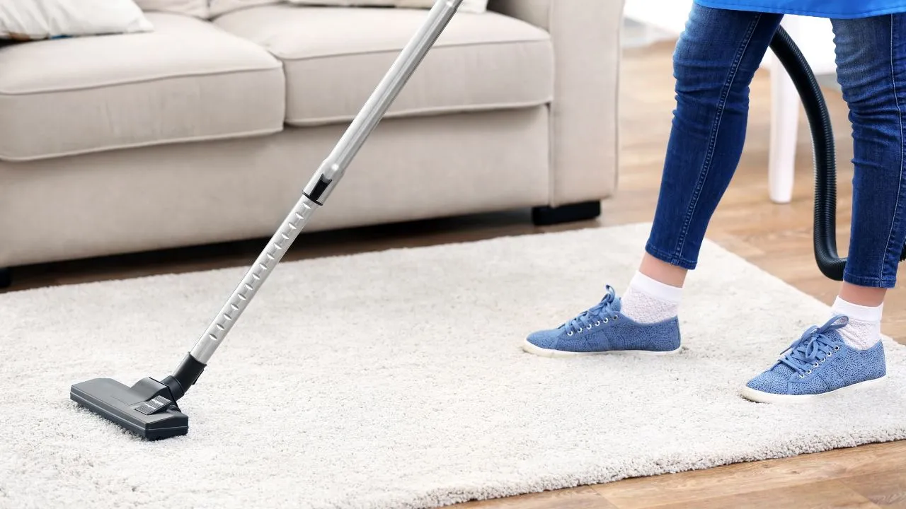 A woman vacuming the the floor