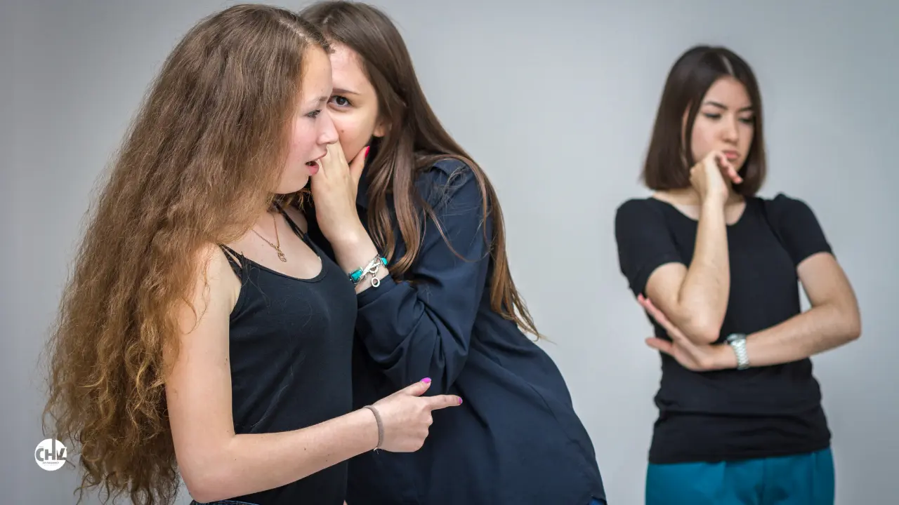 image of two people gossipping about another in front of them