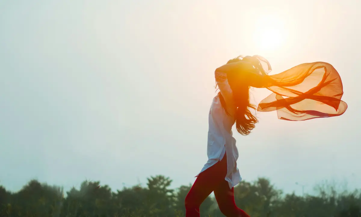 woman dancing free in a field