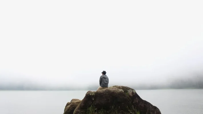 A man by the ocean learning how to stop identifying with your thoughts