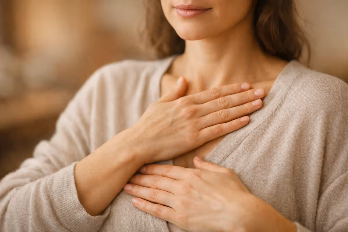 Hands placed over heart and solar plexus during embodiment and somatic awareness practice